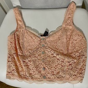 cream colored lace top thats see through except the cups of the bra are covered
